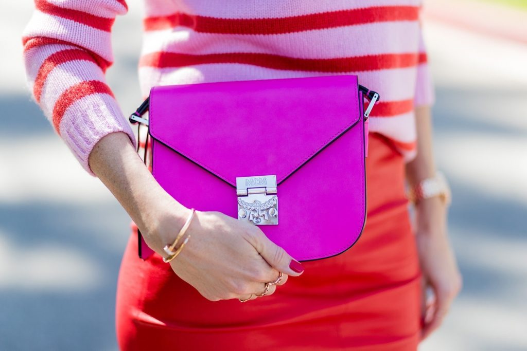 Bandana, MCM, American Retro, Heartbreaker, Le Specs, Gianvito Rossi, IWC Model and fashion blogger Alexandra Lapp wearing a scarf as a bandana from Heartbreaker, a red stretch leather pencil skirt from American Retro, pink and red striped cashmere pullover by Heartbreaker, red lacquer pumps from Gianvito Rossi, an electric-pink Patricia bag, a small crossbody in vachetta leather, complete with a well-organized interior lined in orange sueded nylon, sunglasses from Le Specs, IWC Da Vinci Automatic 36 watch in 18-carat red gold with diamonds and jewelry from AYS (Art Youth Society) on April 20, 2017 in Los Angeles, California.