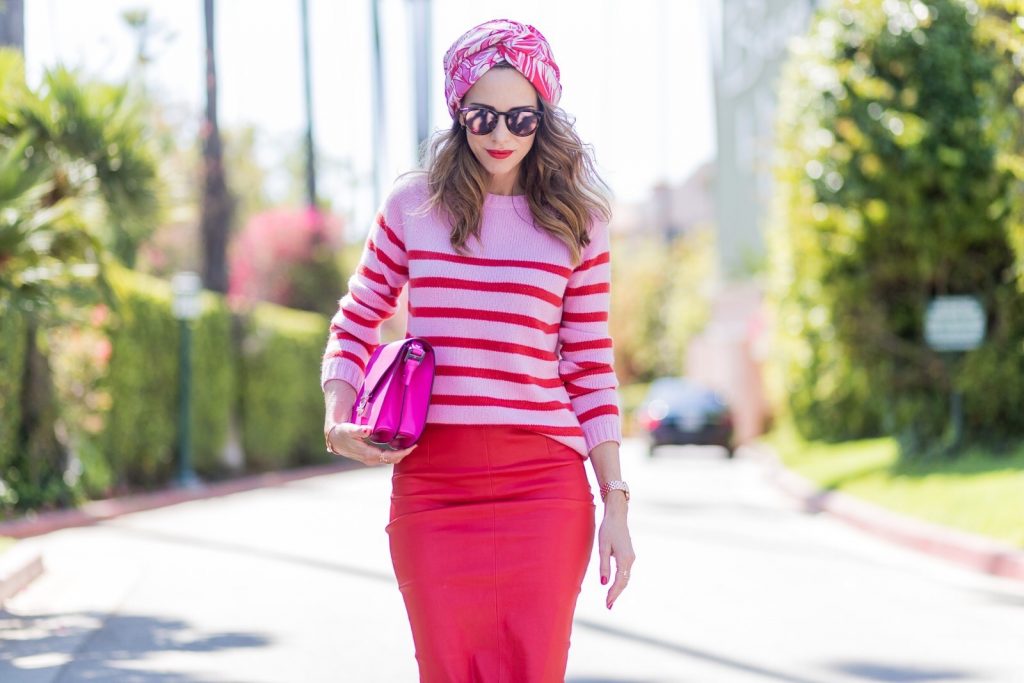 Bandana, MCM, American Retro, Heartbreaker, Le Specs, Gianvito Rossi, IWC Model and fashion blogger Alexandra Lapp wearing a scarf as a bandana from Heartbreaker, a red stretch leather pencil skirt from American Retro, pink and red striped cashmere pullover by Heartbreaker, red lacquer pumps from Gianvito Rossi, an electric-pink Patricia bag, a small crossbody in vachetta leather, complete with a well-organized interior lined in orange sueded nylon, sunglasses from Le Specs, IWC Da Vinci Automatic 36 watch in 18-carat red gold with diamonds and jewelry from AYS (Art Youth Society) on April 20, 2017 in Los Angeles, California.
