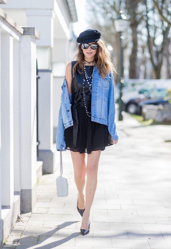 Model and fashion blogger Alexandra Lapp wearing a French Style, the Fergie dress from Tigha with a leather top and pleating skirt, a wide leather waist belt from SET, a Statement Jeans Jacket in a used look from SET, black Dior - Dio(r)evolution metal collier with palladium finish from Dior, three pearl necklaces from Chanel in black and white and little details, the Chanel milk bottle bag from the supermarket collection shaped like a milk carton with pearl-studded âlait de Cocoâ branding, black slingback leather pumps from Dior with JÂ´adior embroidery, Dior sunglasses and a crystal double ring from Guiseppe Zanotti. on March 30, 2017 in Duesseldorf, Germany.