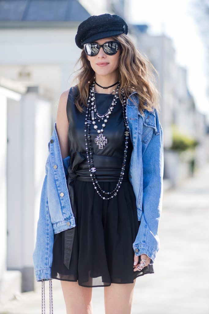 Model and fashion blogger Alexandra Lapp wearing a French Style, the Fergie dress from Tigha with a leather top and pleating skirt, a wide leather waist belt from SET, a Statement Jeans Jacket in a used look from SET, black Dior - Dio(r)evolution metal collier with palladium finish from Dior, three pearl necklaces from Chanel in black and white and little details, the Chanel milk bottle bag from the supermarket collection shaped like a milk carton with pearl-studded âlait de Cocoâ branding, black slingback leather pumps from Dior with JÂ´adior embroidery, Dior sunglasses and a crystal double ring from Guiseppe Zanotti. on March 30, 2017 in Duesseldorf, Germany.