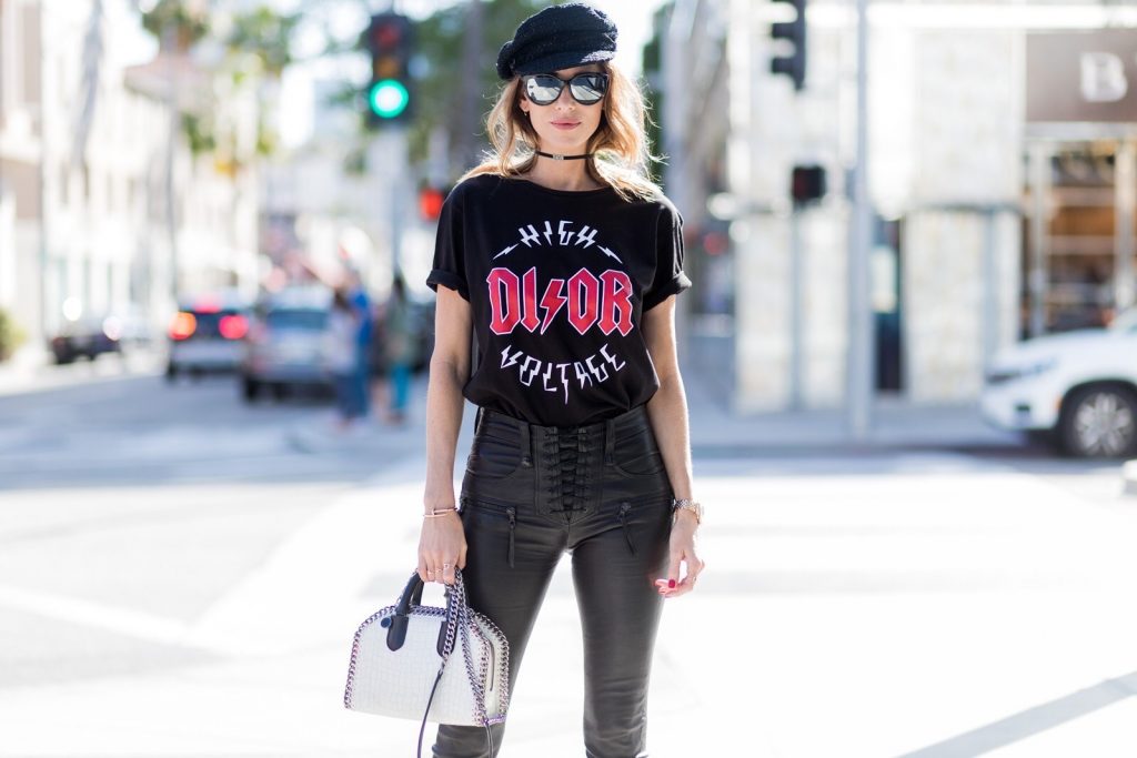 Model and fashion blogger Alexandra Lapp wearing V-Neck-Pumps, a LACE FRONT SKINNY LEATHER PANTS by Unravel, Dior High Voltage T-Shirt from Ecntrc, black and white vegan patent Stella McCartney check pointed toe V-neck-pumps with high-cut toe box, Falabella Box mini faux-leather cross-body bag in black and white, Chanel cap, Diormania sunglasses by Dior and Dior choker, IWC Da Vinci Automatic 36 watch in 18-carat red gold with diamonds and jewelry from AYS (Art Youth Society) on April 20, 2017 in Los Angeles, California.