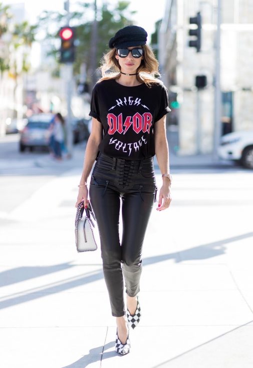 Model and fashion blogger Alexandra Lapp wearing V-Neck-Pumps, a LACE FRONT SKINNY LEATHER PANTS by Unravel, Dior High Voltage T-Shirt from Ecntrc, black and white vegan patent Stella McCartney check pointed toe V-neck-pumps with high-cut toe box, Falabella Box mini faux-leather cross-body bag in black and white, Chanel cap, Diormania sunglasses by Dior and Dior choker, IWC Da Vinci Automatic 36 watch in 18-carat red gold with diamonds and jewelry from AYS (Art Youth Society) on April 20, 2017 in Los Angeles, California.