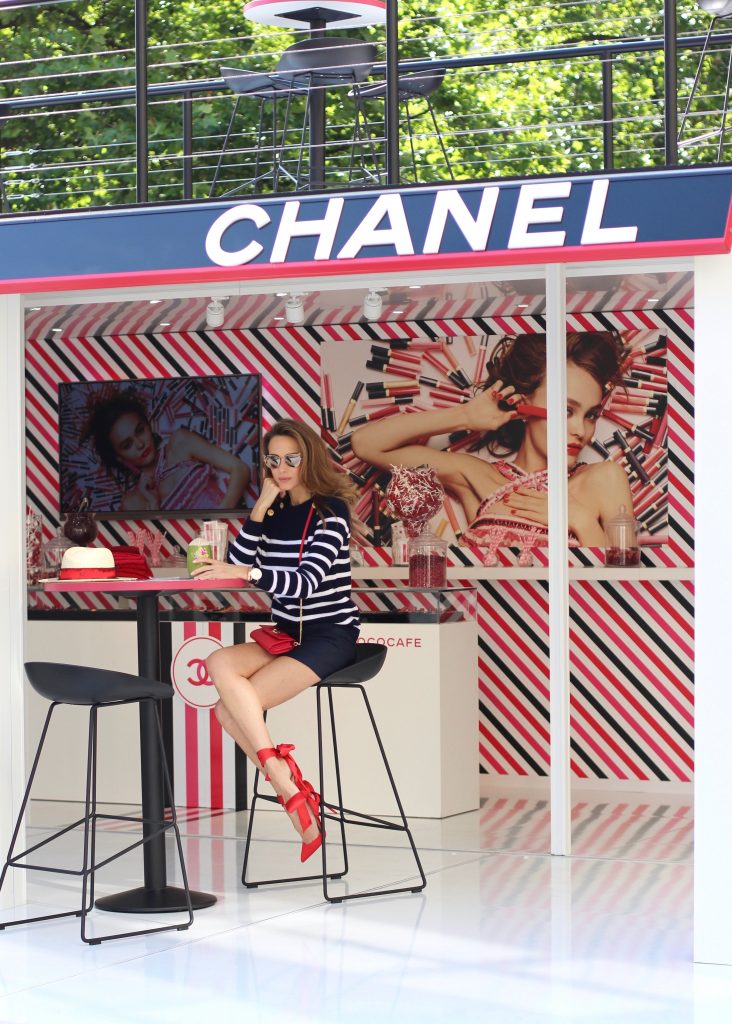 Model and Blogger Alexandra Lapp sitting at Coco Café #cococafe in Duesseldorf, wearing a blue white striped cashmere pullover with gold buttons from Heartbreaker, a dark blue silk shorts by Prada, satin Douce du desert pumps in red with a big silk bow from Christian Louboutin, red crossover purse-bag from Patrizia Pepe and gold cat-eye sunglasses from KARL by Karl Lagerfeld, in Duesseldorf on June, 14th 2017. 