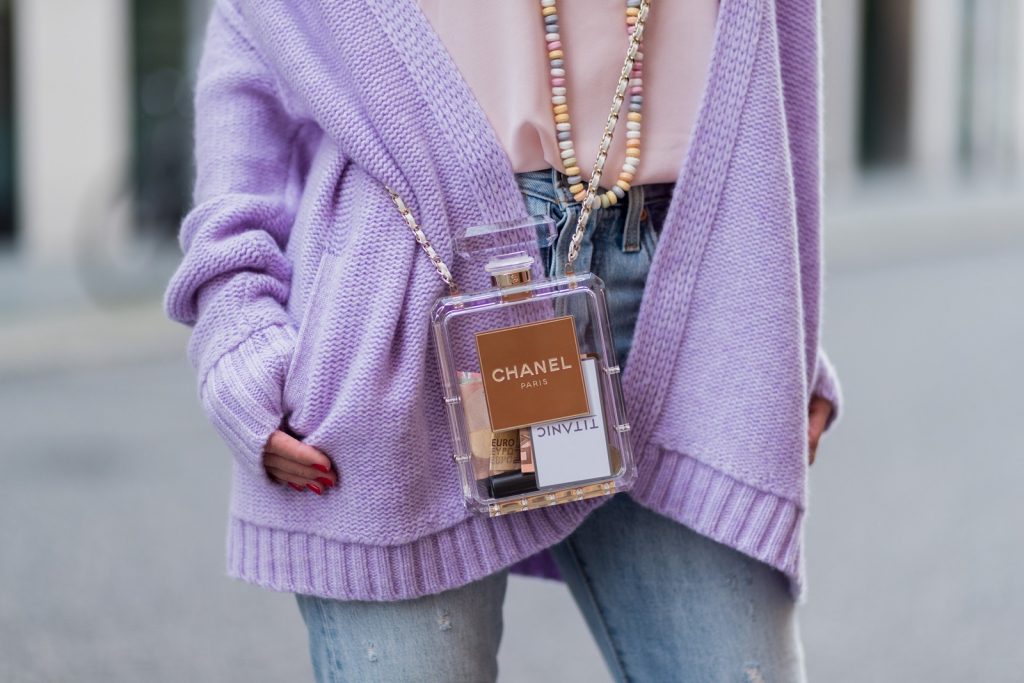 Heartbreaker, Christian Louboutin, Chanel, Levis, Jadicted, Karl, Karl Lagerfeld, Mercedes Benz Fashion Week Berlin, MBFWB, MBFW Alexandra Lapp wearing a pastel purple look, a purple cashmere cardigan by Heartbreaker, a rose tank top in silk from Jadicted, a high waist, non-strech denim, five-pocket 501 skinny jeans from Levis, a candy necklace from Chanel supermarket collection in pastel tones, a Chanel perfume bottle bag in plexiglass and a golden chain with white leather, Christian Louboutin pumps Feerica with nude mesh upper embedded with a Swarovski crystal degrade and Karl Lagerfeld cat-eye sunglasses in the shape of cat ears during the Mercedes-Benz Fashion Week Berlin Spring/Summer 2018 on July 7, 2017 in Berlin, Germany.