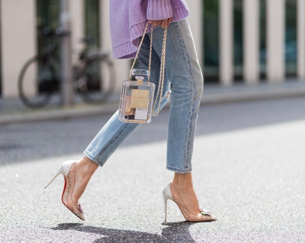 Heartbreaker, Christian Louboutin, Chanel, Levis, Jadicted, Karl, Karl Lagerfeld, Mercedes Benz Fashion Week Berlin, MBFWB, MBFW Alexandra Lapp wearing a pastel purple look, a purple cashmere cardigan by Heartbreaker, a rose tank top in silk from Jadicted, a high waist, non-strech denim, five-pocket 501 skinny jeans from Levis, a candy necklace from Chanel supermarket collection in pastel tones, a Chanel perfume bottle bag in plexiglass and a golden chain with white leather, Christian Louboutin pumps Feerica with nude mesh upper embedded with a Swarovski crystal degrade and Karl Lagerfeld cat-eye sunglasses in the shape of cat ears during the Mercedes-Benz Fashion Week Berlin Spring/Summer 2018 on July 7, 2017 in Berlin, Germany.