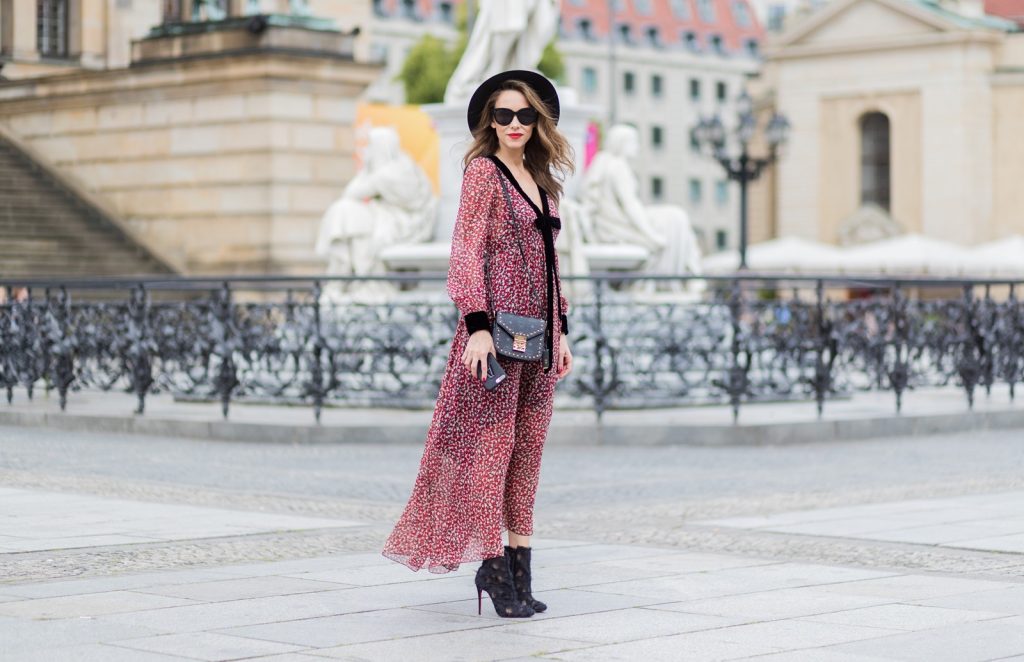 Alexandra Lapp wearing Boho Style, a red and cream floral print maxi dress from Philosophy di Lorenzo Serafini in sheer silk chiffon and bold black trims with a ribbon tie, Toubootfrou ankle boots with rete, organze and suede in black from Christian Louboutin, Celine Audrey sunglasses in black, Maison Maison Michel hat Virginie fedora, MCM Patricia Shoulder Bag in a vintage shape during the Mercedes-Benz Fashion Week Berlin Spring/Summer 2018 on July 7, 2017 in Berlin, Germany. Alexandra Lapp wearing Boho Style, a red and cream floral print maxi dress from Philosophy di Lorenzo Serafini in sheer silk chiffon and bold black trims with a ribbon tie, Toubootfrou ankle boots with rete, organze and suede in black from Christian Louboutin, Celine Audrey sunglasses in black, Maison Maison Michel hat Virginie fedora, MCM Patricia Shoulder Bag in a vintage shape during the Mercedes-Benz Fashion Week Berlin Spring/Summer 2018 on July 7, 2017 in Berlin, Germany.
