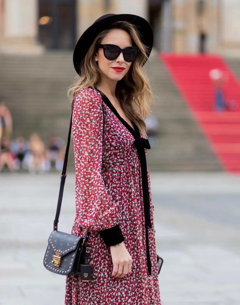 Alexandra Lapp wearing Boho Style, a red and cream floral print maxi dress from Philosophy di Lorenzo Serafini in sheer silk chiffon and bold black trims with a ribbon tie, Toubootfrou ankle boots with rete, organze and suede in black from Christian Louboutin, Celine Audrey sunglasses in black, Maison Maison Michel hat Virginie fedora, MCM Patricia Shoulder Bag in a vintage shape during the Mercedes-Benz Fashion Week Berlin Spring/Summer 2018 on July 7, 2017 in Berlin, Germany. Alexandra Lapp wearing Boho Style, a red and cream floral print maxi dress from Philosophy di Lorenzo Serafini in sheer silk chiffon and bold black trims with a ribbon tie, Toubootfrou ankle boots with rete, organze and suede in black from Christian Louboutin, Celine Audrey sunglasses in black, Maison Maison Michel hat Virginie fedora, MCM Patricia Shoulder Bag in a vintage shape during the Mercedes-Benz Fashion Week Berlin Spring/Summer 2018 on July 7, 2017 in Berlin, Germany.