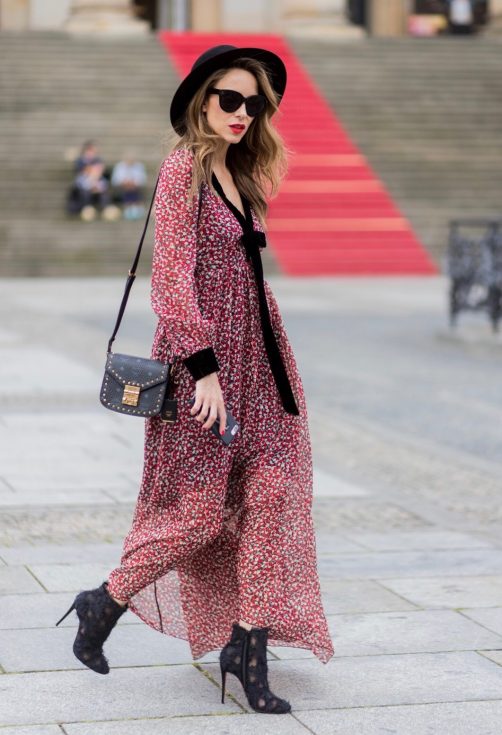 Alexandra Lapp wearing Boho Style, a red and cream floral print maxi dress from Philosophy di Lorenzo Serafini in sheer silk chiffon and bold black trims with a ribbon tie, Toubootfrou ankle boots with rete, organze and suede in black from Christian Louboutin, Celine Audrey sunglasses in black, Maison Maison Michel hat Virginie fedora, MCM Patricia Shoulder Bag in a vintage shape during the Mercedes-Benz Fashion Week Berlin Spring/Summer 2018 on July 7, 2017 in Berlin, Germany. Alexandra Lapp wearing Boho Style, a red and cream floral print maxi dress from Philosophy di Lorenzo Serafini in sheer silk chiffon and bold black trims with a ribbon tie, Toubootfrou ankle boots with rete, organze and suede in black from Christian Louboutin, Celine Audrey sunglasses in black, Maison Maison Michel hat Virginie fedora, MCM Patricia Shoulder Bag in a vintage shape during the Mercedes-Benz Fashion Week Berlin Spring/Summer 2018 on July 7, 2017 in Berlin, Germany.