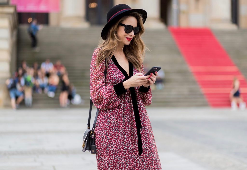 Alexandra Lapp wearing Boho Style, a red and cream floral print maxi dress from Philosophy di Lorenzo Serafini in sheer silk chiffon and bold black trims with a ribbon tie, Toubootfrou ankle boots with rete, organze and suede in black from Christian Louboutin, Celine Audrey sunglasses in black, Maison Maison Michel hat Virginie fedora, MCM Patricia Shoulder Bag in a vintage shape during the Mercedes-Benz Fashion Week Berlin Spring/Summer 2018 on July 7, 2017 in Berlin, Germany. Alexandra Lapp wearing Boho Style, a red and cream floral print maxi dress from Philosophy di Lorenzo Serafini in sheer silk chiffon and bold black trims with a ribbon tie, Toubootfrou ankle boots with rete, organze and suede in black from Christian Louboutin, Celine Audrey sunglasses in black, Maison Maison Michel hat Virginie fedora, MCM Patricia Shoulder Bag in a vintage shape during the Mercedes-Benz Fashion Week Berlin Spring/Summer 2018 on July 7, 2017 in Berlin, Germany.