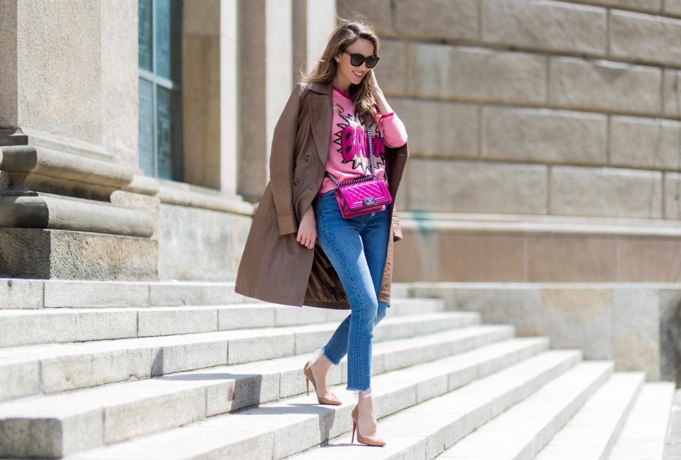 Alexandra Lapp wearing a leather coat in cognac by Riani, a round neck pullover, printed with BAM in comic style and pailettes, Levis Wedgie Icon Fit jeans in slim fit and dark blue, a Boy bag in metallic pink patent leather, Gucci sunglasses and cognac So Kate high heels from Christian Louboutin during the Mercedes-Benz Fashion Week Berlin Spring/Summer 2018 on July 7, 2017 in Berlin, Germany.