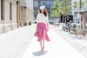 Alexandra Lapp (model, blogger) wearing the Milla Tote bag from MCM which is crafted in Spanish leather, white knitwear from Oui Fashion, Chanel cap in white, Dior Reflected Aviator sunglasses in gold from Dior and Stessy K lip print pumps from Aldo during the Mercedes-Benz Fashion Week Berlin Spring/Summer 2018 on July 6, 2017 in Berlin, Germany.