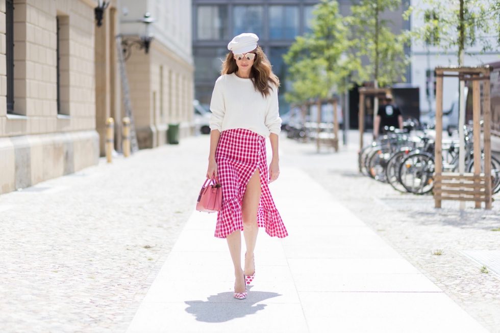 Alexandra Lapp (model, blogger) wearing the Milla Tote bag from MCM which is crafted in Spanish leather, white knitwear from Oui Fashion, Chanel cap in white, Dior Reflected Aviator sunglasses in gold from Dior and Stessy K lip print pumps from Aldo during the Mercedes-Benz Fashion Week Berlin Spring/Summer 2018 on July 6, 2017 in Berlin, Germany.