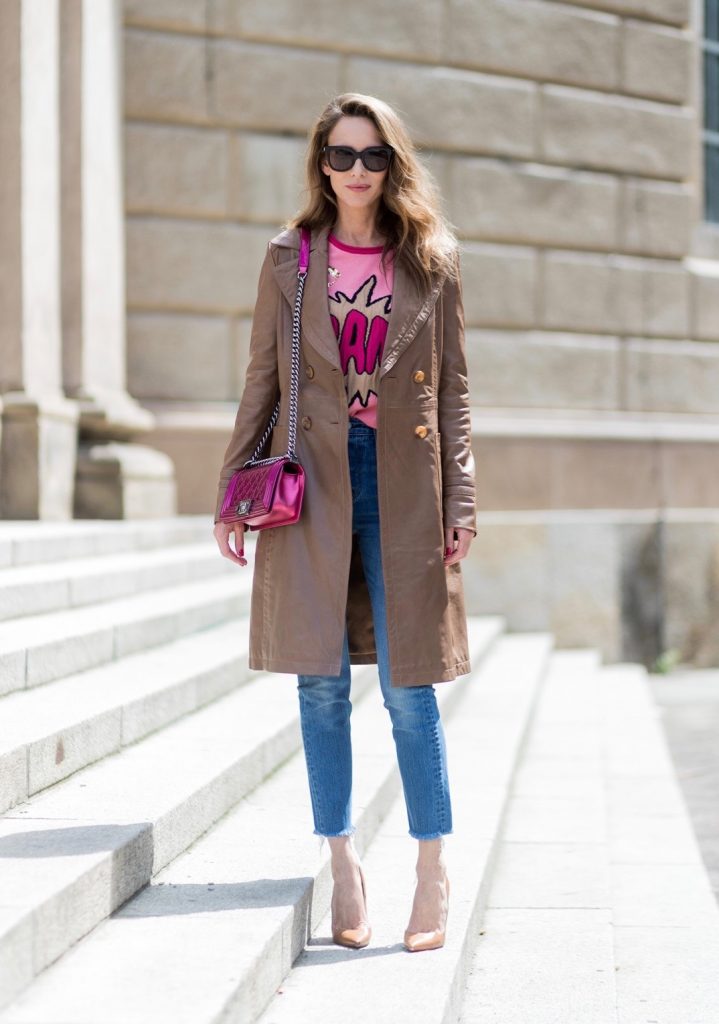 Alexandra Lapp wearing a leather coat in cognac by Riani, a round neck pullover, printed with BAM in comic style and pailettes, Levis Wedgie Icon Fit jeans in slim fit and dark blue, a Boy bag in metallic pink patent leather, Gucci sunglasses and cognac So Kate high heels from Christian Louboutin during the Mercedes-Benz Fashion Week Berlin Spring/Summer 2018 on July 7, 2017 in Berlin, Germany.