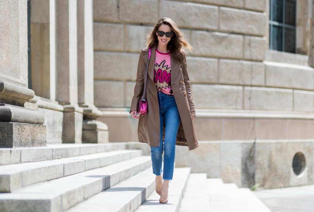Alexandra Lapp wearing a leather coat in cognac by Riani, a round neck pullover, printed with BAM in comic style and pailettes, Levis Wedgie Icon Fit jeans in slim fit and dark blue, a Boy bag in metallic pink patent leather, Gucci sunglasses and cognac So Kate high heels from Christian Louboutin during the Mercedes-Benz Fashion Week Berlin Spring/Summer 2018 on July 7, 2017 in Berlin, Germany.