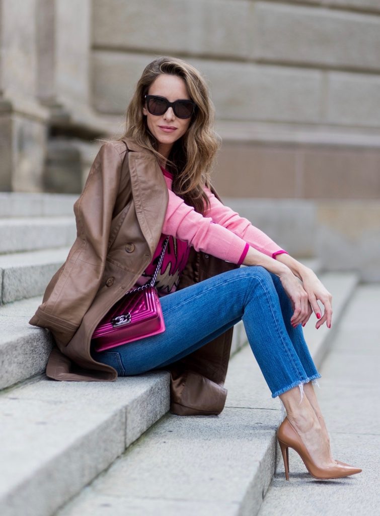 Alexandra Lapp wearing a leather coat in cognac by Riani, a round neck pullover, printed with BAM in comic style and pailettes, Levis Wedgie Icon Fit jeans in slim fit and dark blue, a Boy bag in metallic pink patent leather, Gucci sunglasses and cognac So Kate high heels from Christian Louboutin during the Mercedes-Benz Fashion Week Berlin Spring/Summer 2018 on July 7, 2017 in Berlin, Germany.