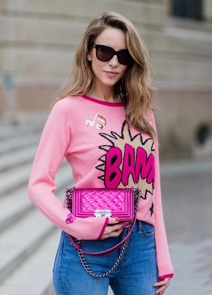 Alexandra Lapp wearing a leather coat in cognac by Riani, a round neck pullover, printed with BAM in comic style and pailettes, Levis Wedgie Icon Fit jeans in slim fit and dark blue, a Boy bag in metallic pink patent leather, Gucci sunglasses and cognac So Kate high heels from Christian Louboutin during the Mercedes-Benz Fashion Week Berlin Spring/Summer 2018 on July 7, 2017 in Berlin, Germany.