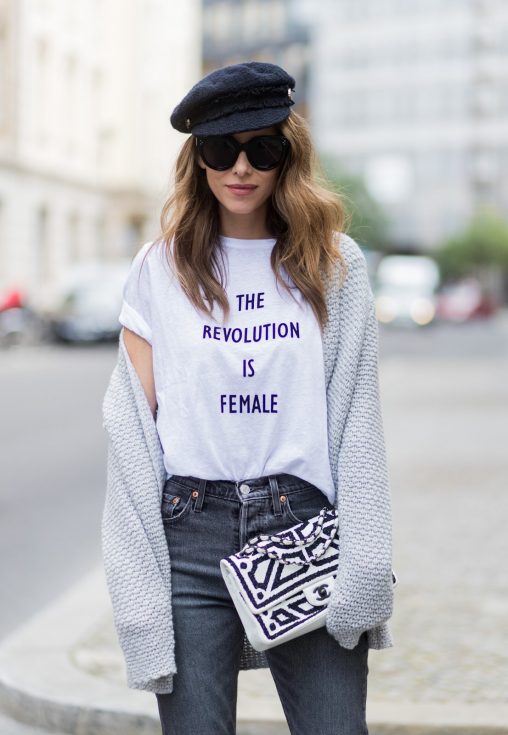 Alexandra Lapp wearing a T-Shirt from H&M, printed with The Revolution Is Female, a high waist, non-strech denim, five-pocket 501 skinny jeans from Levis in grey, Cashmere cardigan in grey, Roger Vivier pumps in a sharp cut and sheeny satin fabric in black and white stripes with crystal flower-embellished buckle at the front and sling-back shape and the 2.55 classic Chanel bag in white leather with black pearls during the Mercedes-Benz Fashion Week Berlin Spring/Summer 2018 on July 7, 2017 in Berlin, Germany.