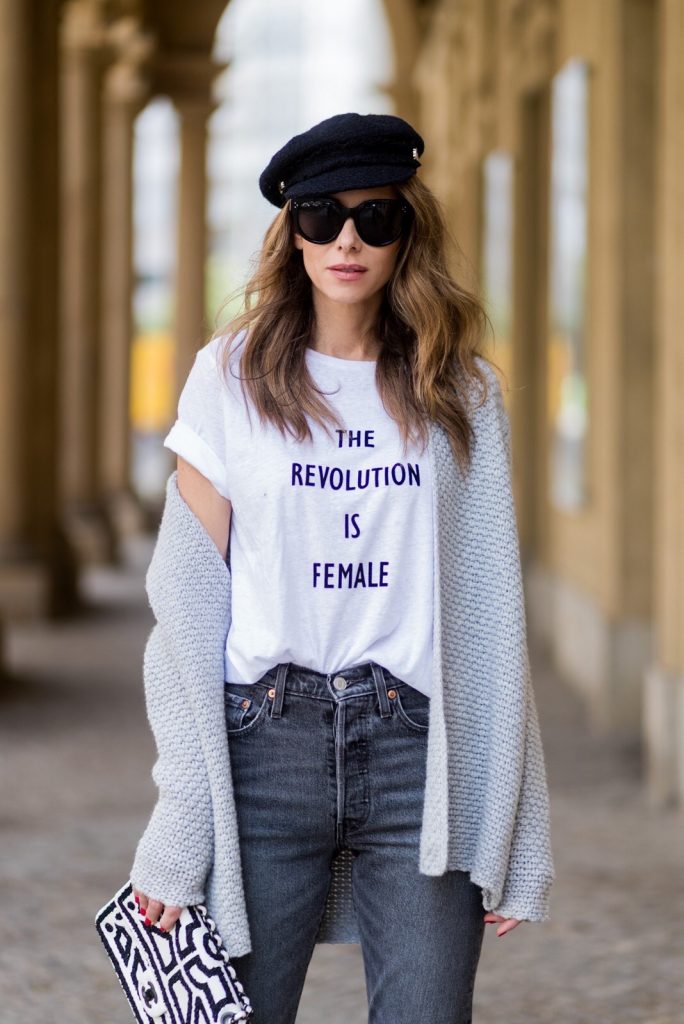 Alexandra Lapp wearing a T-Shirt from H&M, printed with The Revolution Is Female, a high waist, non-strech denim, five-pocket 501 skinny jeans from Levis in grey, Cashmere cardigan in grey, Roger Vivier pumps in a sharp cut and sheeny satin fabric in black and white stripes with crystal flower-embellished buckle at the front and sling-back shape and the 2.55 classic Chanel bag in white leather with black pearls during the Mercedes-Benz Fashion Week Berlin Spring/Summer 2018 on July 7, 2017 in Berlin, Germany.