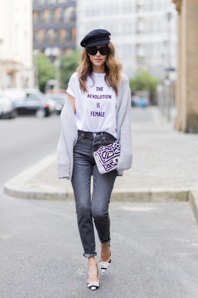 Alexandra Lapp wearing a T-Shirt from H&M, printed with The Revolution Is Female, a high waist, non-strech denim, five-pocket 501 skinny jeans from Levis in grey, Cashmere cardigan in grey, Roger Vivier pumps in a sharp cut and sheeny satin fabric in black and white stripes with crystal flower-embellished buckle at the front and sling-back shape and the 2.55 classic Chanel bag in white leather with black pearls during the Mercedes-Benz Fashion Week Berlin Spring/Summer 2018 on July 7, 2017 in Berlin, Germany.