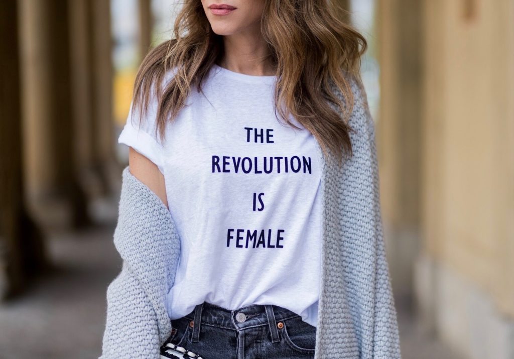 Alexandra Lapp wearing a T-Shirt from H&M, printed with The Revolution Is Female, a high waist, non-strech denim, five-pocket 501 skinny jeans from Levis in grey, Cashmere cardigan in grey, Roger Vivier pumps in a sharp cut and sheeny satin fabric in black and white stripes with crystal flower-embellished buckle at the front and sling-back shape and the 2.55 classic Chanel bag in white leather with black pearls during the Mercedes-Benz Fashion Week Berlin Spring/Summer 2018 on July 7, 2017 in Berlin, Germany.