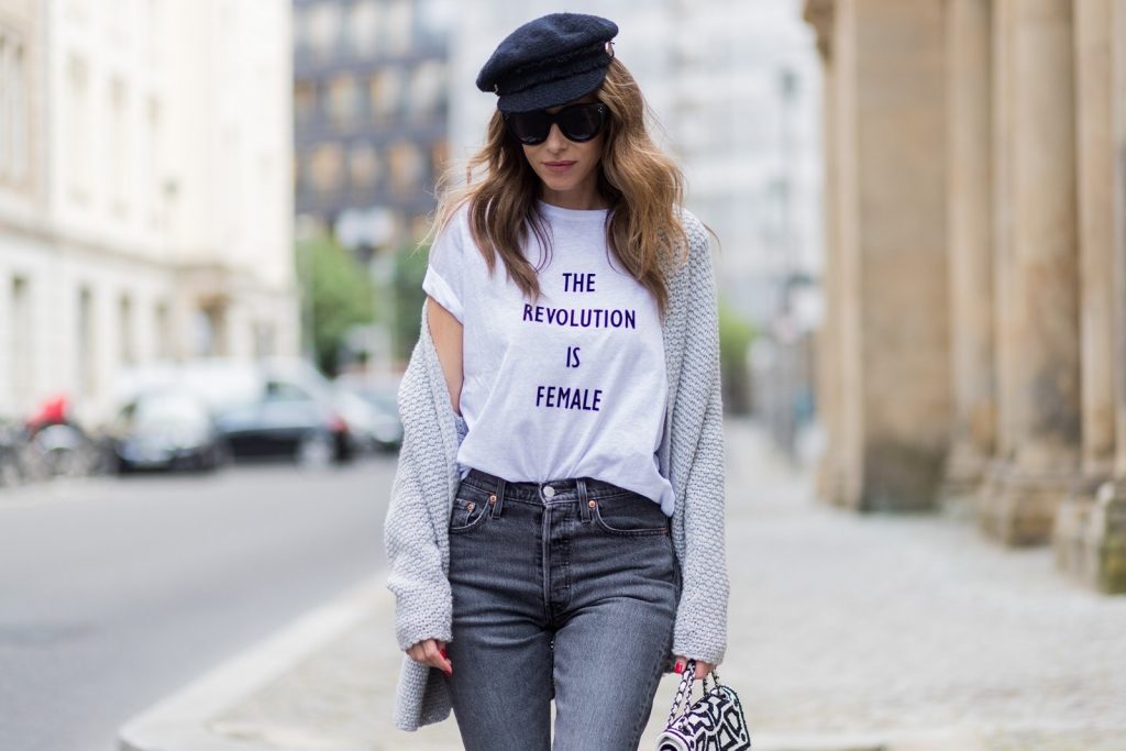 Alexandra Lapp wearing a T-Shirt from H&M, printed with The Revolution Is Female, a high waist, non-strech denim, five-pocket 501 skinny jeans from Levis in grey, Cashmere cardigan in grey, Roger Vivier pumps in a sharp cut and sheeny satin fabric in black and white stripes with crystal flower-embellished buckle at the front and sling-back shape and the 2.55 classic Chanel bag in white leather with black pearls during the Mercedes-Benz Fashion Week Berlin Spring/Summer 2018 on July 7, 2017 in Berlin, Germany.