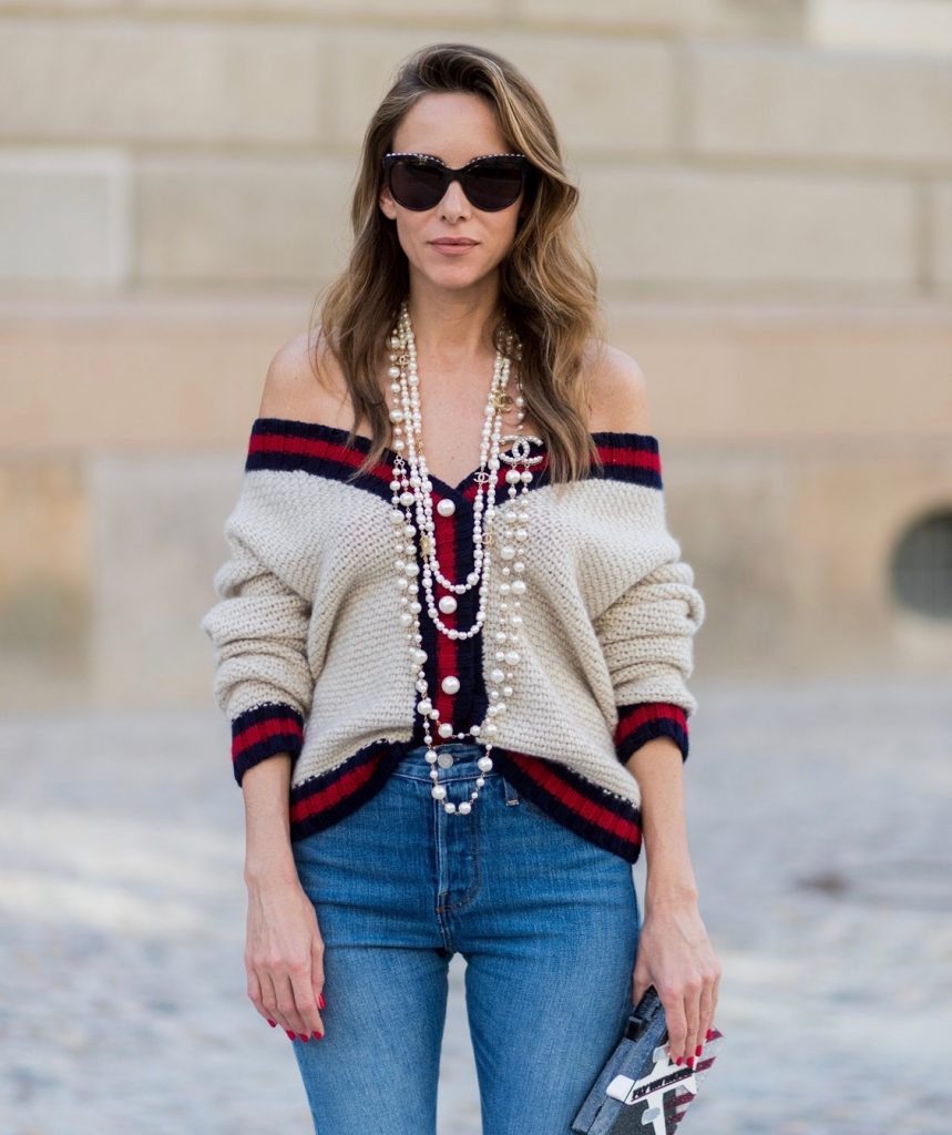 Alexandra Lapp wearing a cashmere cardigan with pearls in beige with a collar in blue and red Levis Wedgie Icon Fit jeans in slim fit and dark blue, a long, pearl necklace from Chanel with the Chanel Logo, brown sunglasses with pearls from Chanel, Fly with Karl clutch from Karl Lagerfeld and cognac So Kate high heels from Christian Louboutin during the Mercedes-Benz Fashion Week Berlin Spring/Summer 2018 on July 7, 2017 in Berlin, Germany.
