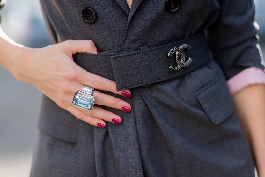 Model and fashion blogger Alexandra Lapp wearing a blazer dress in grey by Dsquared with matching waist belt, Chanel broach, camouflage Stark backpack from MCM, Diormania sunglasses from Dior, Giuseppe Zanotti open-toe ankle booties, pendant in grey gold with topaz and ring in grey gold with aquamarin by Schubart jewelry on August 4, 2017 in Duesseldorf, Germany.