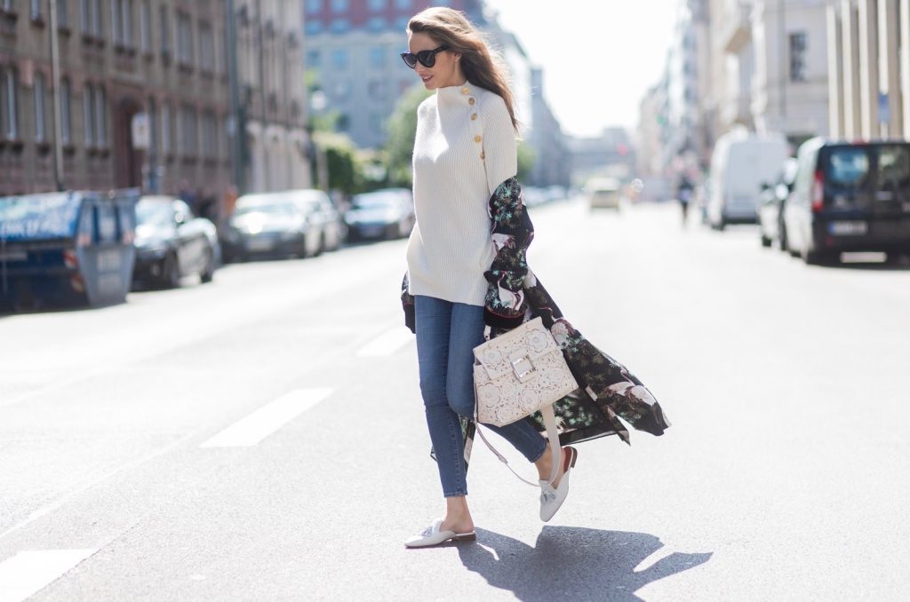 Model and fashion blogger Alexandra Lapp wearing white leather tassel mules from Santoni. a off white cashmere pullover by Heartbreaker, Kimono with velvet collar from Zara, Adriano Goldschmied AG jeans, Roger Viv bag in suede with waterjet cut Guipure detailing, metal buckle and details, removable strap in trapezium shape, silver mirrored sunglasses from Le Spec during the Mercedes-Benz Fashion Week Berlin Spring/Summer 2018 on July 8, 2017 in Berlin, Germany.
