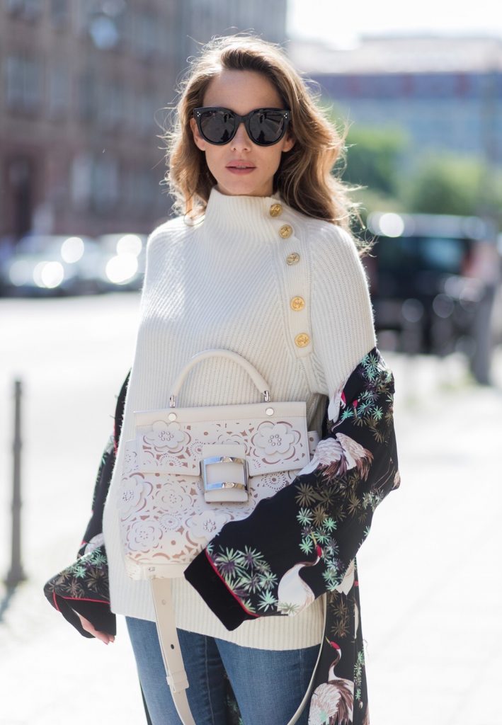 Model and fashion blogger Alexandra Lapp wearing white leather tassel mules from Santoni. a off white cashmere pullover by Heartbreaker, Kimono with velvet collar from Zara, Adriano Goldschmied AG jeans, Roger Viv bag in suede with waterjet cut Guipure detailing, metal buckle and details, removable strap in trapezium shape, silver mirrored sunglasses from Le Spec during the Mercedes-Benz Fashion Week Berlin Spring/Summer 2018 on July 8, 2017 in Berlin, Germany.