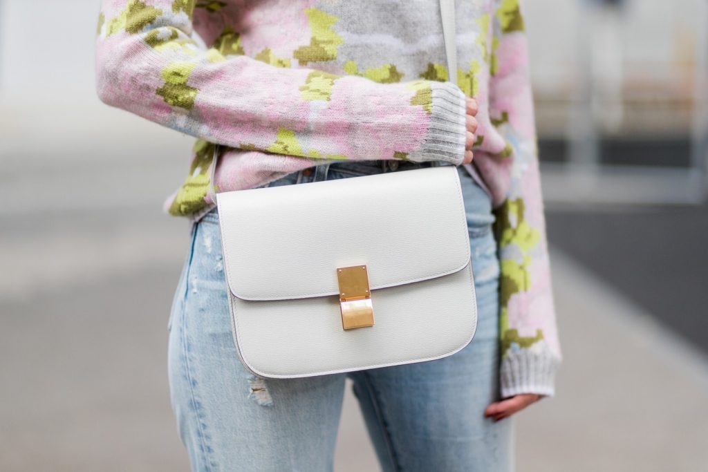 Cashmere love for Model and fashion blogger Alexandra Lapp, who is wearing colorful cashmere pullover by Heartbreaker, high waist five-pocket 501 skinny jeans from Levis, cashmere scarf in grey by Heartbreaker, white snake pumps from Christian Louboutin, round sunglasses in white from Chrome Hearts, Celine Box bag in light grey and a big statement ring in rose gold with baguette diamonds by Schubart Goldschmiede on August 5, 2017 in Duesseldorf, Germany.