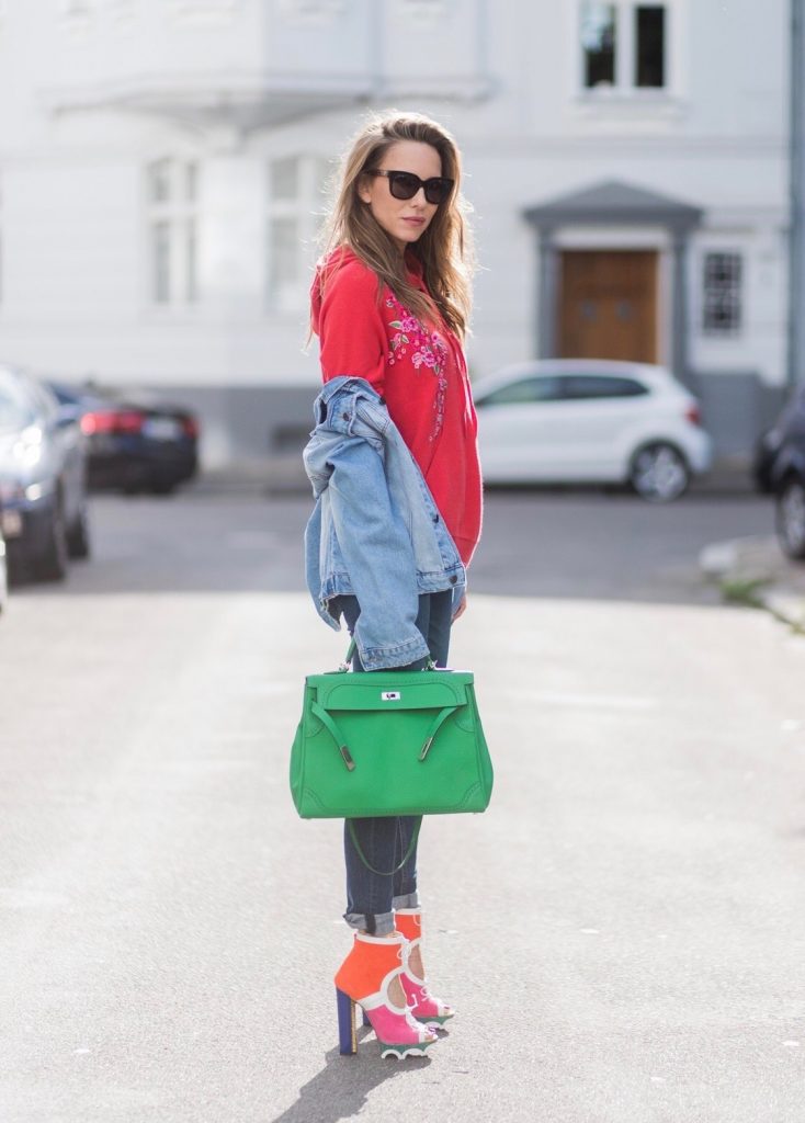 Color Blocking, Christian Louboutin, Heartbreaker, AG Jeans, SET, Hermès, Gucci Model and fashion blogger Alexandra Lapp wearing color blocking, oversized denim jacket by SET, high waist denim from Rag and Bone Jeans, red cashmere hoodie with pink flowers by Heartbreaker, green Kelly bag by Hermes, Lolacramp color blocking heels from Christian Louboutin and Gucci sunglasses on August 5, 2017 in Duesseldorf, Germany.