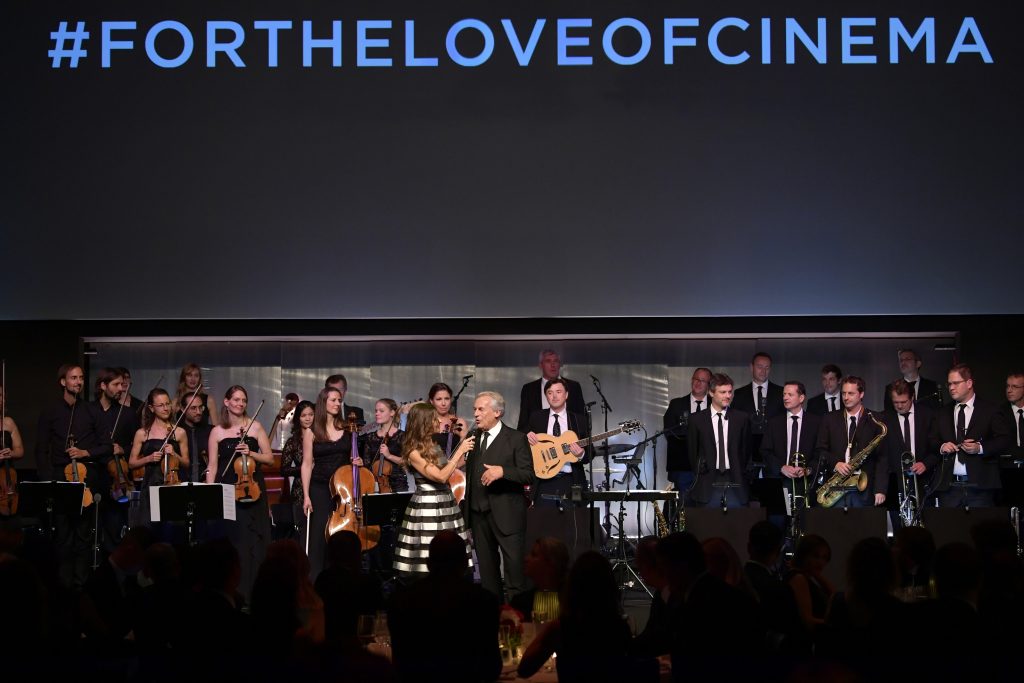 ZURICH Film Festival, SWITZERLAND - SEPTEMBER 30: Host Sandra Studer speaks to bandleader Pepe Lienhard at the IWC 'For the Love of Cinema' Gala Dinner at AURA Zurich on 30 September, 2017 in Zurich, Switzerland. During the event, actor James Marsden presented the third 'Filmmaker Award', a sponsorship worth CHF 100,000. The award was set up by the Association for the Promotion of Film in Switzerland ('Verein zur Filmförderung in der Schweiz'). (Photo by Harold Cunningham/Getty Images for IWC)