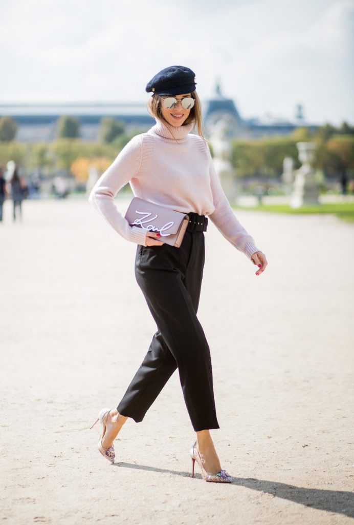 Alexandra Lapp wearing high waist pants in black from Zara, cashmere turtleneck in light pink from Jil Sander, light pink calf leather logo plaque shoulder bag from Karl Lagerfeld, Karl Lagerfeld bag, mirrored sunglasses by Le Specs, hat by Chanel, IWC Portugieser watch and Christian Louboutin Feerica heels with crystal embellished flower and glitter is seen during Paris Fashion Week Spring/Summer 2018 on September 29, 2017 in Paris, France.