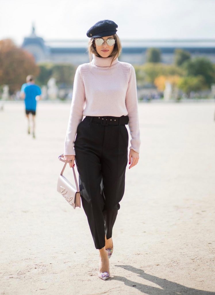 Alexandra Lapp wearing high waist pants in black from Zara, cashmere turtleneck in light pink from Jil Sander, light pink calf leather logo plaque shoulder bag from Karl Lagerfeld, Karl Lagerfeld bag, mirrored sunglasses by Le Specs, hat by Chanel, IWC Portugieser watch and Christian Louboutin Feerica heels with crystal embellished flower and glitter is seen during Paris Fashion Week Spring/Summer 2018 on September 29, 2017 in Paris, France.