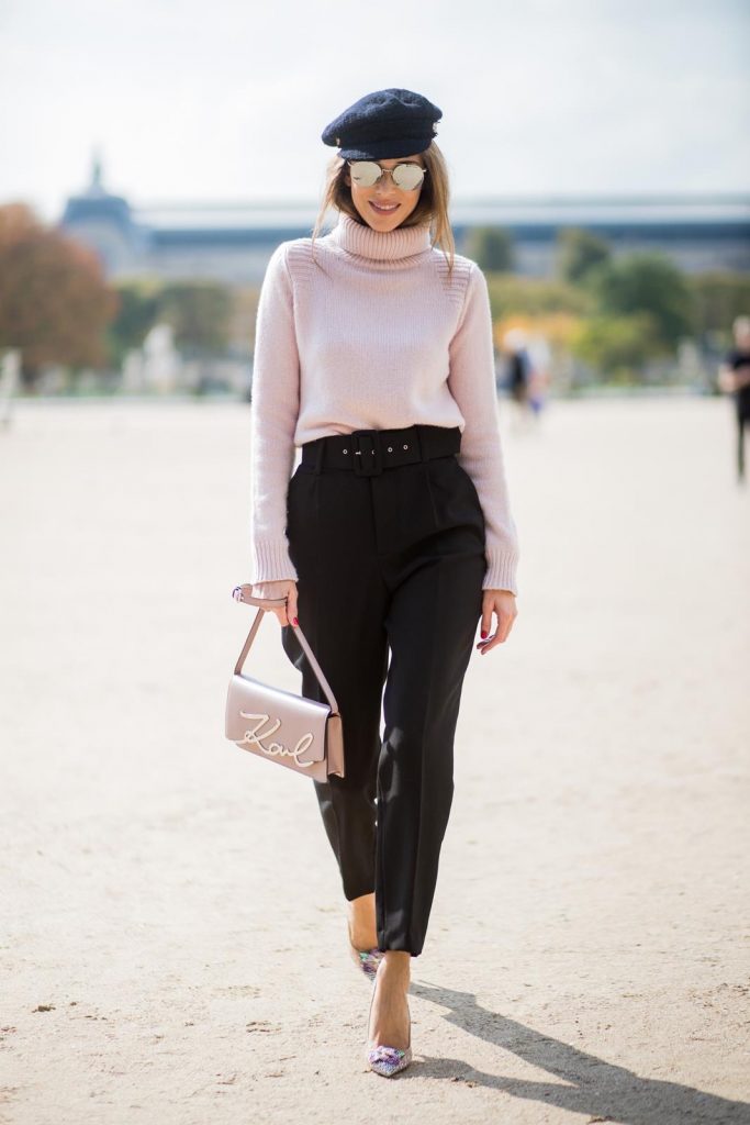 Alexandra Lapp wearing high waist pants in black from Zara, cashmere turtleneck in light pink from Jil Sander, light pink calf leather logo plaque shoulder bag from Karl Lagerfeld, Karl Lagerfeld bag, mirrored sunglasses by Le Specs, hat by Chanel, IWC Portugieser watch and Christian Louboutin Feerica heels with crystal embellished flower and glitter is seen during Paris Fashion Week Spring/Summer 2018 on September 29, 2017 in Paris, France.
