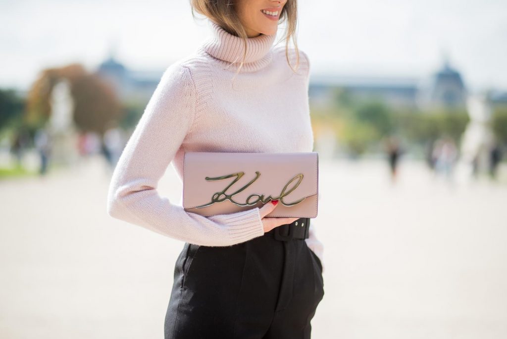 Alexandra Lapp wearing high waist pants in black from Zara, cashmere turtleneck in light pink from Jil Sander, light pink calf leather logo plaque shoulder bag from Karl Lagerfeld, Karl Lagerfeld bag, mirrored sunglasses by Le Specs, hat by Chanel, IWC Portugieser watch and Christian Louboutin Feerica heels with crystal embellished flower and glitter is seen during Paris Fashion Week Spring/Summer 2018 on September 29, 2017 in Paris, France.