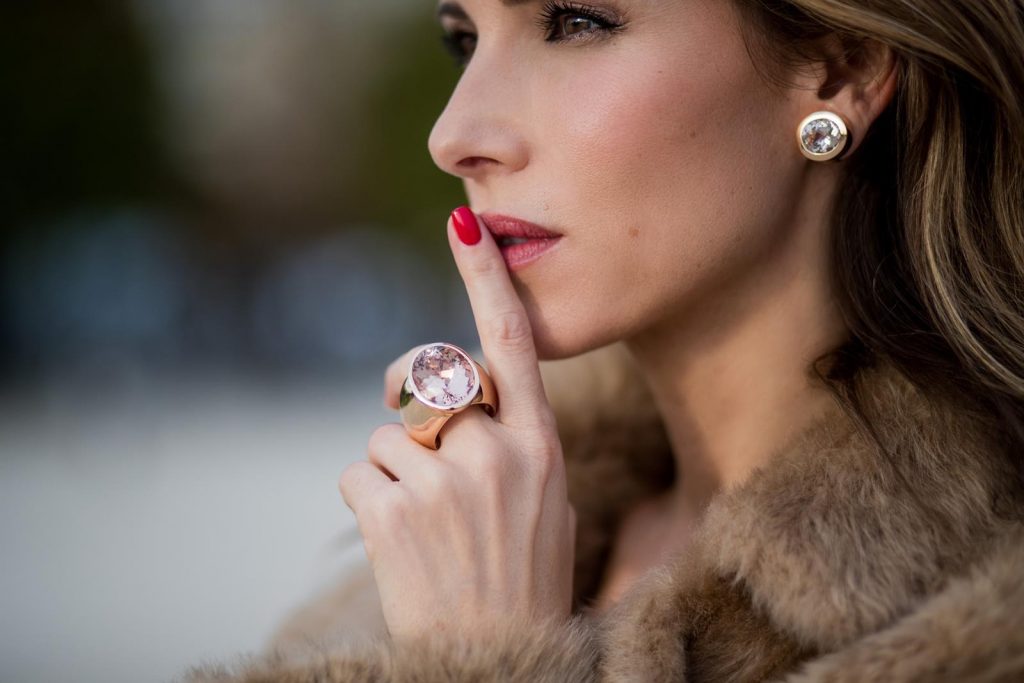 Alexandra Lapp wearing Morganite jewelry, rings and earrings by Schubart an oversized MCM Stark Pouch in Shearling Stripe, a lambskin coat in light brown by Yves Salomon, black and white big waist-belt from Balmain and striped Christian Louboutin 'So Kate' heels is seen during Paris Fashion Week Spring/Summer 2018 on September 28, 2017 in Paris, France.