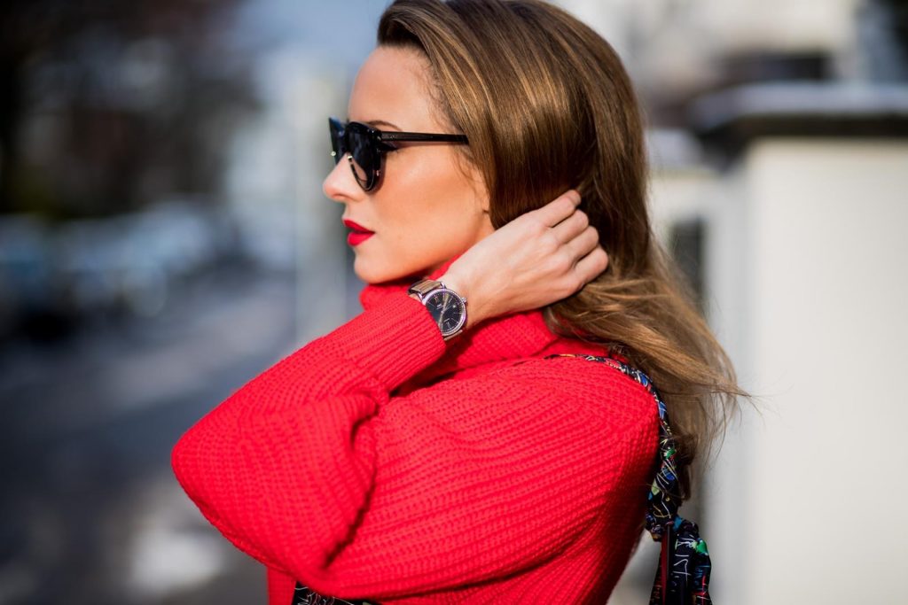 H&M, AG Jeans, Saint Laurent, Christian Louboutin, Dior Alexandra Lapp wearing a cropped red turtleneck from H&M, Adriano Goldschmied Boyfriend denim from AG Jeans, Diormania sunglasses by Dior, Opyum 110 ankle boots in patent from Dior, Paloma medium handbag from Christian Louboutin, IWC watch on December 11, 2017 in Duesseldorf, Germany.