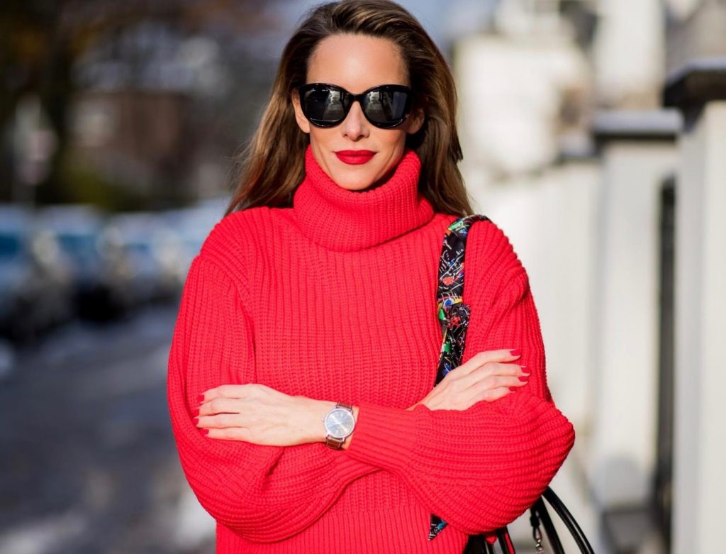 H&M, AG Jeans, Saint Laurent, Christian Louboutin, Dior Alexandra Lapp wearing a cropped red turtleneck from H&M, Adriano Goldschmied Boyfriend denim from AG Jeans, Diormania sunglasses by Dior, Opyum 110 ankle boots in patent from Dior, Paloma medium handbag from Christian Louboutin, IWC watch on December 11, 2017 in Duesseldorf, Germany.