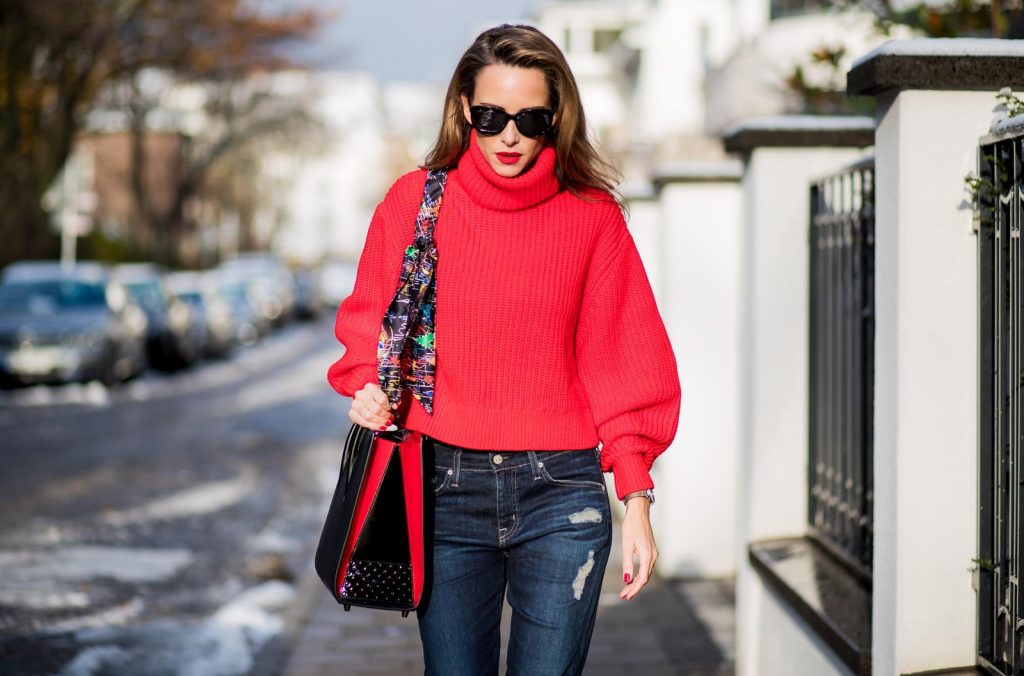 H&M, AG Jeans, Saint Laurent, Christian Louboutin, Dior Alexandra Lapp wearing a cropped red turtleneck from H&M, Adriano Goldschmied Boyfriend denim from AG Jeans, Diormania sunglasses by Dior, Opyum 110 ankle boots in patent from Dior, Paloma medium handbag from Christian Louboutin, IWC watch on December 11, 2017 in Duesseldorf, Germany.