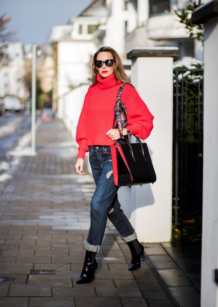 H&M, AG Jeans, Saint Laurent, Christian Louboutin, Dior Alexandra Lapp wearing a cropped red turtleneck from H&M, Adriano Goldschmied Boyfriend denim from AG Jeans, Diormania sunglasses by Dior, Opyum 110 ankle boots in patent from Dior, Paloma medium handbag from Christian Louboutin, IWC watch on December 11, 2017 in Duesseldorf, Germany.
