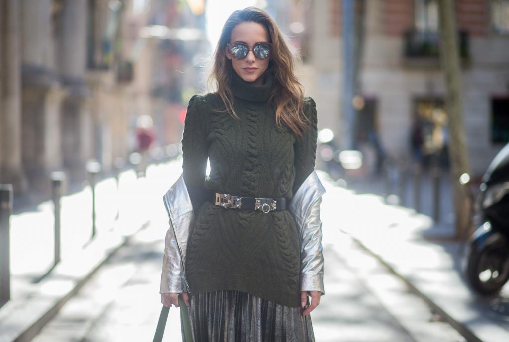 Alexandra Lapp wearing metallic look, a pleated skirt in a washed out silver metallic and black style, long knitted dark green Celine turtle neck pullover with cable stitch, black waist belt from Hermes with heavy silver buckle and silver stud details, short cut silver leather jacket with zippers from Set Fashion, silver metallic boots from H&M, large green Patricia Hobo bag from MCM and sunglasses from Le Specs on November 28, 2017 in Barcelona, Spain.