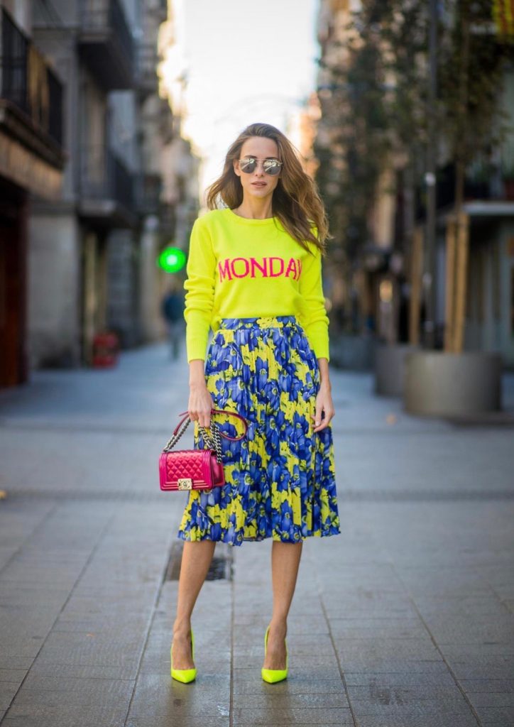 Alexandra Lapp wearing the yellow Alberta Ferretti Monday jumper, pleated skirt with flower prints by Balenciaga, a dark red quilted small boy bag by Chanel, neon yellow pumps by Christian Louboutin and silver Ray Ban sunglasses on November 29, 2017 in Barcelona, Spain.