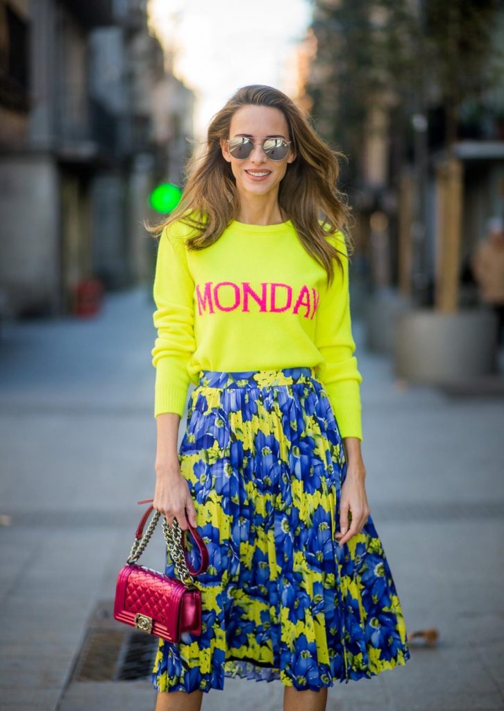 Alexandra Lapp wearing the yellow Alberta Ferretti Monday jumper, pleated skirt with flower prints by Balenciaga, a dark red quilted small boy bag by Chanel, neon yellow pumps by Christian Louboutin and silver Ray Ban sunglasses on November 29, 2017 in Barcelona, Spain.
