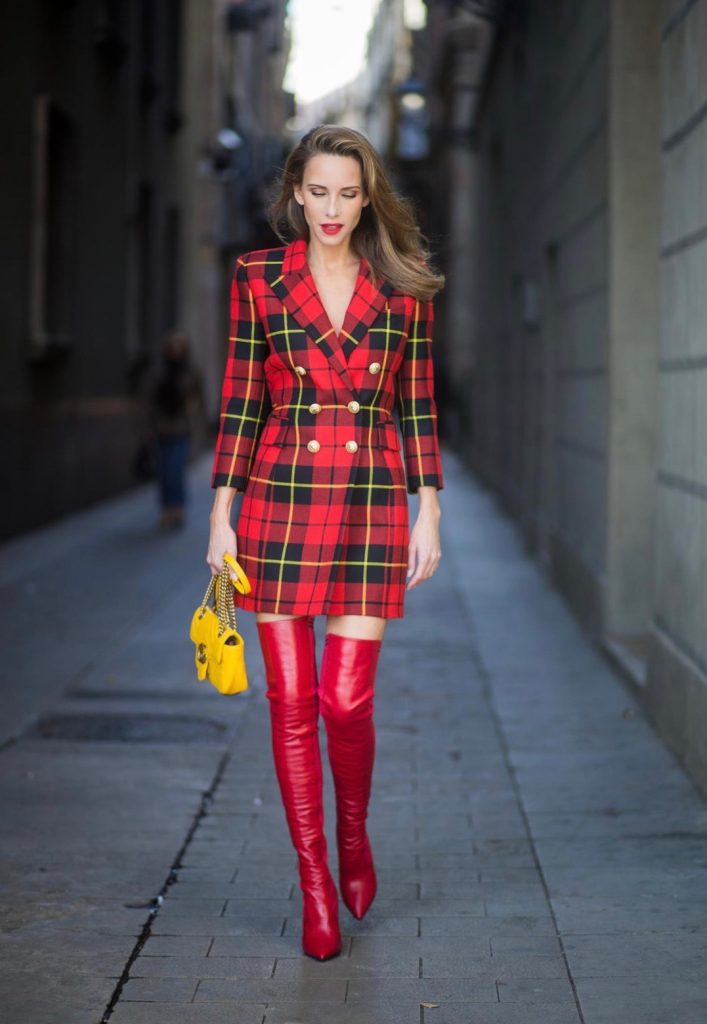 Alexandra Lapp wearing a look all about red, a red checked plaid wool blazer-dress with golden buttons by Balmain, ribbed knit Fendi thigh boots in red Rockoko leather, a yellow Marmont matelasse shoulder bag by Gucci and black Audrey sunglasses by Celine on November 27, 2017 in Barcelona, Spain.