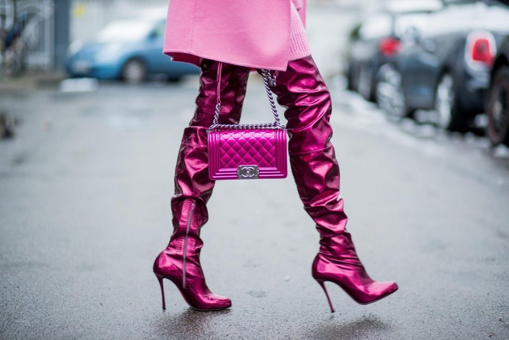 On Wednesdays we wear pink, Alexandra Lapp wearing overknee boots in metallic pink from Christian Louboutin, metallic pink Boy bag from Chanel, pink sunglasses from Le Specs, light pink knit dress from H&M and light pink cashmere coat from Prada on December 10, 2017 in Duesseldorf, Germany.