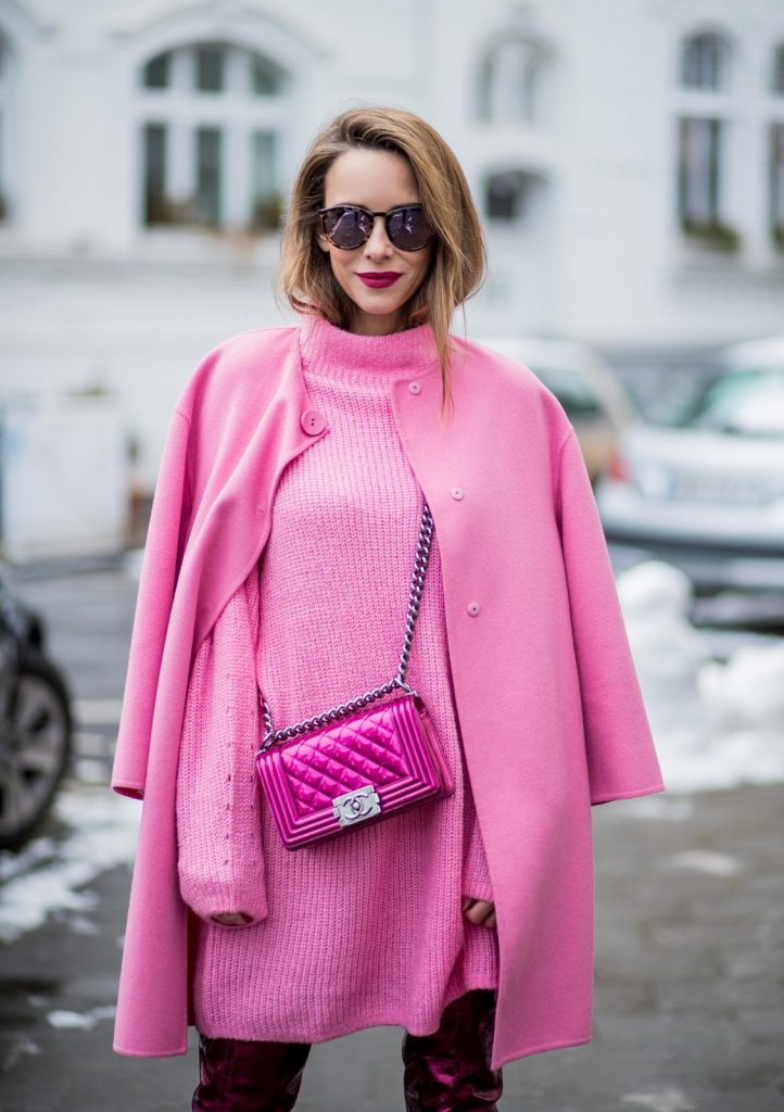 On Wednesdays we wear pink, Alexandra Lapp wearing overknee boots in metallic pink from Christian Louboutin, metallic pink Boy bag from Chanel, pink sunglasses from Le Specs, light pink knit dress from H&M and light pink cashmere coat from Prada on December 10, 2017 in Duesseldorf, Germany.