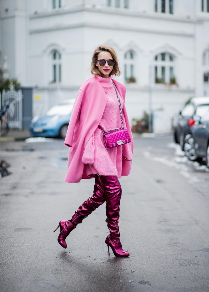 On Wednesdays we wear pink, Alexandra Lapp wearing overknee boots in metallic pink from Christian Louboutin, metallic pink Boy bag from Chanel, pink sunglasses from Le Specs, light pink knit dress from H&M and light pink cashmere coat from Prada on December 10, 2017 in Duesseldorf, Germany.