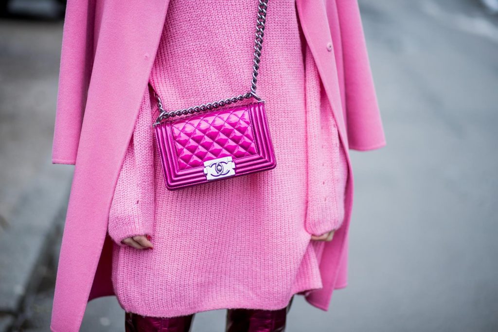 On Wednesdays we wear pink, Alexandra Lapp wearing overknee boots in metallic pink from Christian Louboutin, metallic pink Boy bag from Chanel, pink sunglasses from Le Specs, light pink knit dress from H&M and light pink cashmere coat from Prada on December 10, 2017 in Duesseldorf, Germany.