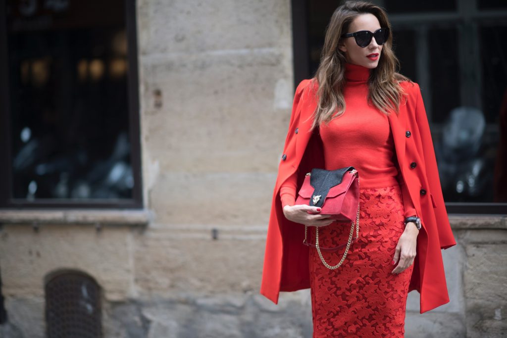 Alexandra Lapp seen wearing an orange outfit from Marc Cain, Manolo Blahnik heels in black with orange and Céline Audrey sunglasses, in the streets of Paris on September 27, 2017 in Paris, France.